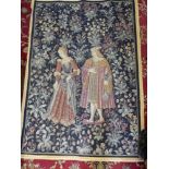 A machine made wall hanging depicting a Medieval lady and gentleman and flowers, gold and white