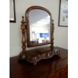 A Victorian mahogany framed swing toilet mirror with arched top, on shaped base with hinged jewel