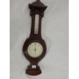 A barometer and thermometer on a shaped mahogany mount with curved base