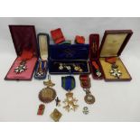 A collection of early 20th Century French Legion D'Honneur enamel medals in leather and other cases