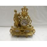 A 19th Century French mantel clock with white enamel dial, drum shaped movement, in a gilded spelter