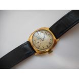 A gentleman's wristwatch in an 18ct. gold case, on a black leather strap