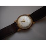 A gentleman's Felca wristwatch in a gold case, on a leather strap