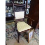 An oak framed armchair with shaped and bobbin splats, upholstered seat, on turned legs and an