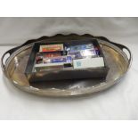 A silver plated oval galleried tray and a selection of souvenir spoons