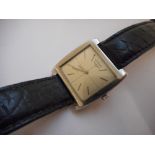 A gentleman's Longines wristwatch in a square steel case, on a leather strap