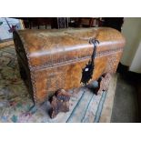 A modern embossed dome top leather covered trunk with studded and metal banding, on leather