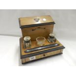 A Victorian stationery box, the raised back with hinged compartment, fitted two glass inkwells and