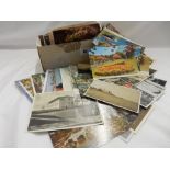 A quantity of black and white and coloured postcards