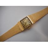 A lady's Accurist wristwatch in a 9ct. gold case, on a 9ct. gold integral bracelet