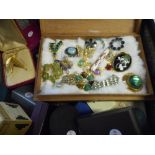 A lady's blue vanity case containing a selection of costume jewellery including brooches, an Aynsley