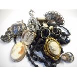 Two rows of faceted black glass beads, a carved shell cameo brooch in a silver coloured metal frame,