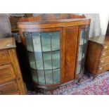 A mahogany display cabinet with shaped raised back, bow front, fitted two bow glass doors, on