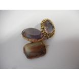 An oval gold brooch set centre amethyst coloured stone, a similar ditto and one other brooch set