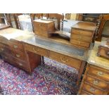 An Edwardian mahogany desk, the raised back with centre recess flanked to each side by three