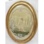 A Georgian oval silkwork picture of a lady in a garden, gilt framed