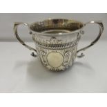 A Victorian silver porringer with scroll handles, punched and gadroon decoration to the rim, leaf