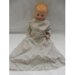 An Armand Marseille baby doll, dressed