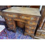 A Georgian design walnut knee hole desk fitted two frieze drawers, central cupboard flanked to