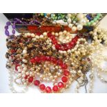 A large selection of costume jewellery including bead necklaces, brooches etc..