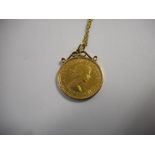 A gold sovereign for 1966 mounted as a pendant in a 9ct. gold frame, on a 9ct. gold ropetwist