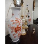 A pair of alabaster tablelamp bases and a pair of porcelain tablelamps bases decorated flowers in