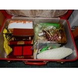 A red suitcase containing a large quantity of costume jewellery including dress watches, earrings,