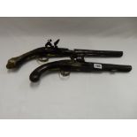 An antique pistol with decorative brass mounts, engraved London and one other antique pistol with