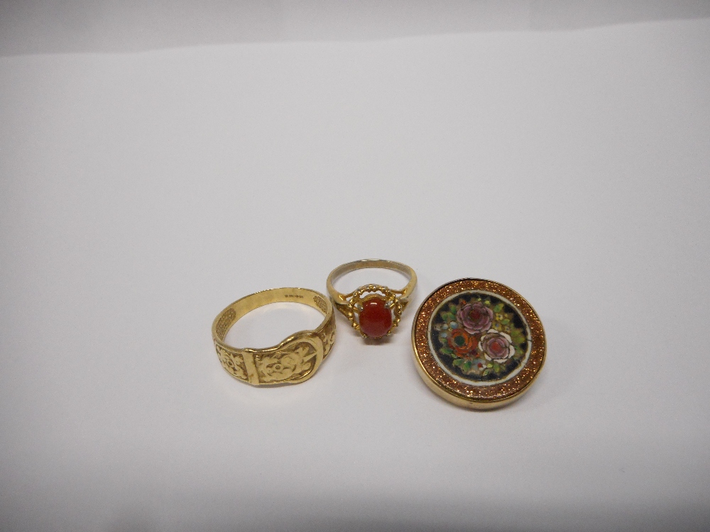 A gentleman's 9ct. gold buckle ring, a lady's dress ring set orange stone, on a gold coloured