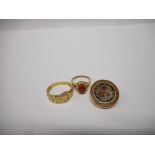 A gentleman's 9ct. gold buckle ring, a lady's dress ring set orange stone, on a gold coloured