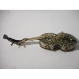 A Continental silver trinket box in the form of a musical instrument with repousse decoration of