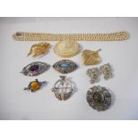 A selection of costume jewellery including simulated pearls, a cameo style brooch, amber style