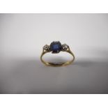 A lady's ring set centre sapphire flanked to each side by two diamonds, on a gold shank, a lady's