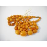 A quantity of graduated amber beads - 59.5g