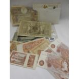 A selection of bank notes including ten shillings, Japanese 50 cent notes etc..
