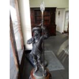 A spelter lamp in the form of a cavalier holding a staff - 41 1/2in. high overall