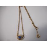 A lady's necklace set sapphire surrounded by old cut diamonds, on a gold coloured metal chain