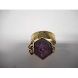 A 9ct. gold wedding band and a lady's ring set hexagonal amethyst coloured stone, on a 9ct. gold