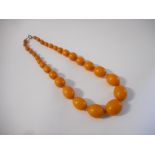 A row of graduated amber style beads