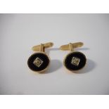 A pair of 9ct. gold cufflinks, the top set black onyx and diamond