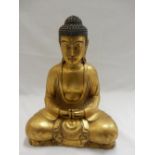 A gilded resin model of a seated Buddha - 13in. high and 9in. wide