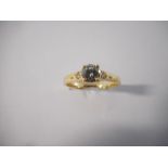 A lady's solitaire diamond ring with diamond set shoulders, on an 18ct. gold shank