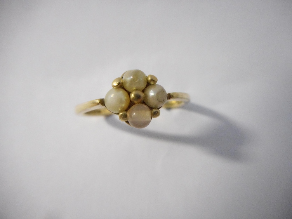 A lady's ring set seed pearls, on a 9ct. gold shank