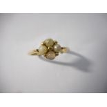 A lady's ring set seed pearls, on a 9ct. gold shank