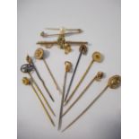 A 15ct. gold stick pin set amethyst and seed pearl, a 9ct. gold stick pin with knot design