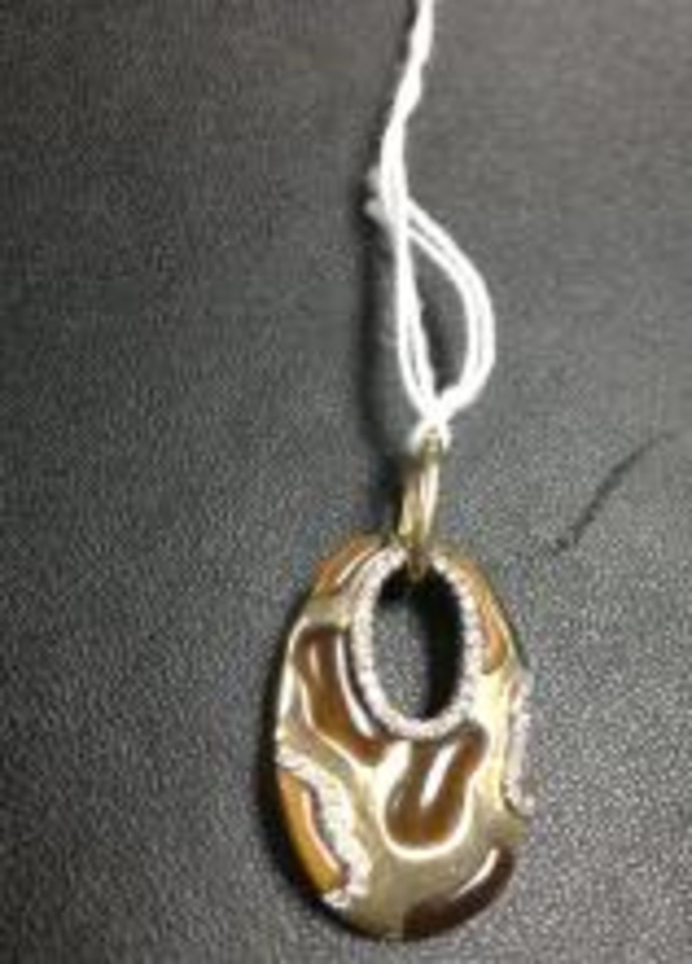 14ct yellow gold pendant set with Tigers Eye's and diamonds
