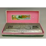 A Hohner The Echo mouth organ,