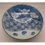 A studio pottery blue and white footed bowl decorated with fish, signed,
