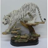 A large Academy model of a Siberian tiger on a plinth,