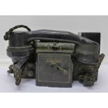 A military issue field telephone,